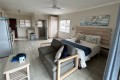 Banana Beach Club F1, a self-catering ground-floor studio in Melville on the Hibiscus Coast, located 50m from the beach, ideal for a small family holiday.