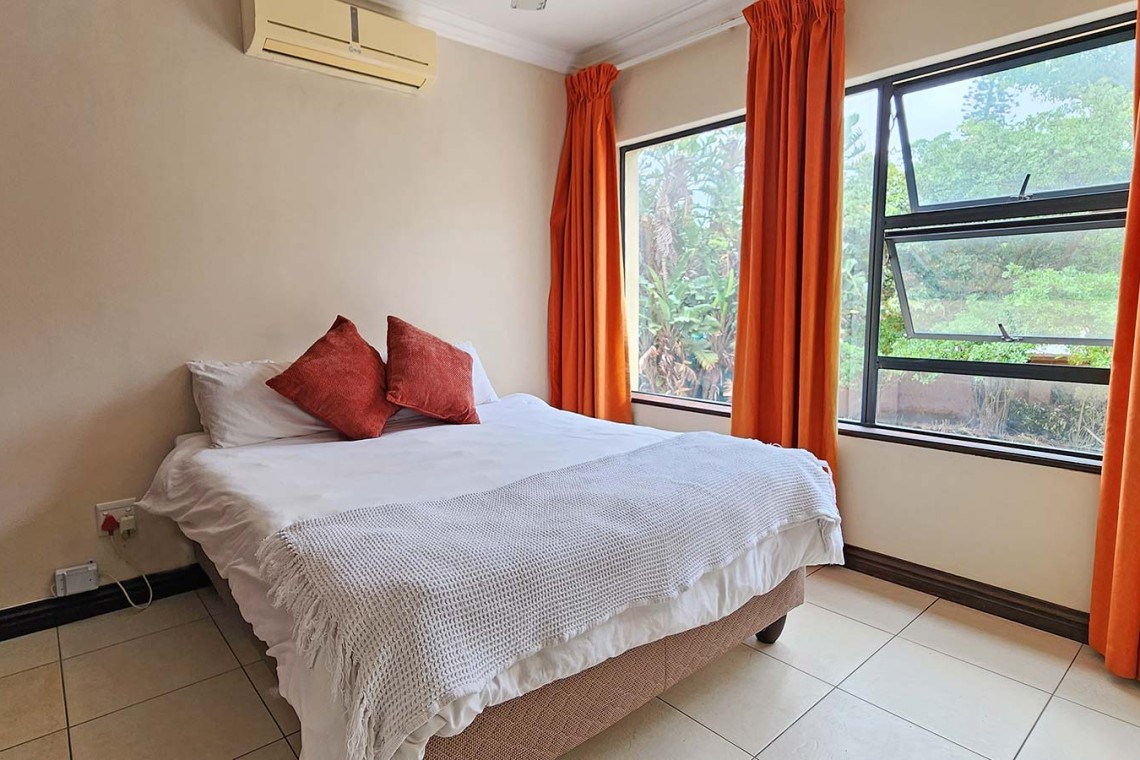 Kubu Bali 18, a 7-sleeper self-catering holiday flat in Shelly Beach with sea views, a spacious patio with gas braai, and beachfront access.