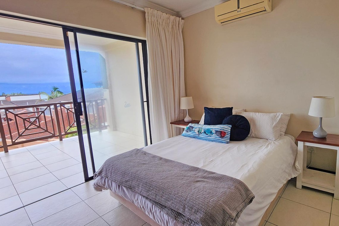 Kubu Bali 18, a 7-sleeper self-catering holiday flat in Shelly Beach with sea views, a spacious patio with gas braai, and beachfront access.