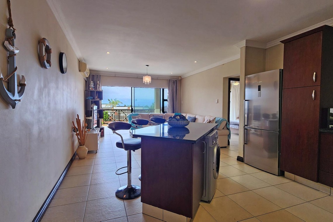 Kubu Bali 18, a 7-sleeper self-catering holiday flat in Shelly Beach with sea views, a spacious patio with gas braai, and beachfront access.