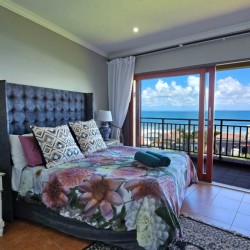 Stay at Kuta Beach 17 Ramsgate, a stunning 4-bedroom, 8-sleeper self-catering holiday apartment KZN with sea views, Wi-Fi, pool, and Smart TV.