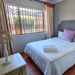 Stay at Kuta Beach 17 Ramsgate, a stunning 4-bedroom, 8-sleeper self-catering holiday apartment KZN with sea views, Wi-Fi, pool, and Smart TV.