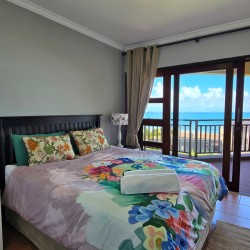 Stay at Kuta Beach 17 Ramsgate, a stunning 4-bedroom, 8-sleeper self-catering holiday apartment KZN with sea views, Wi-Fi, pool, and Smart TV.