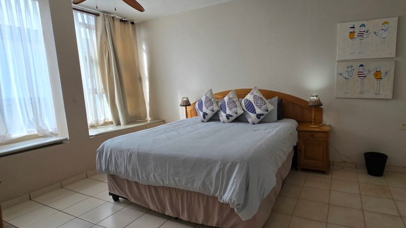 Main bedroom with ensuite bathroom at C Front 11 penthouse, 7-sleeper holiday accommodation