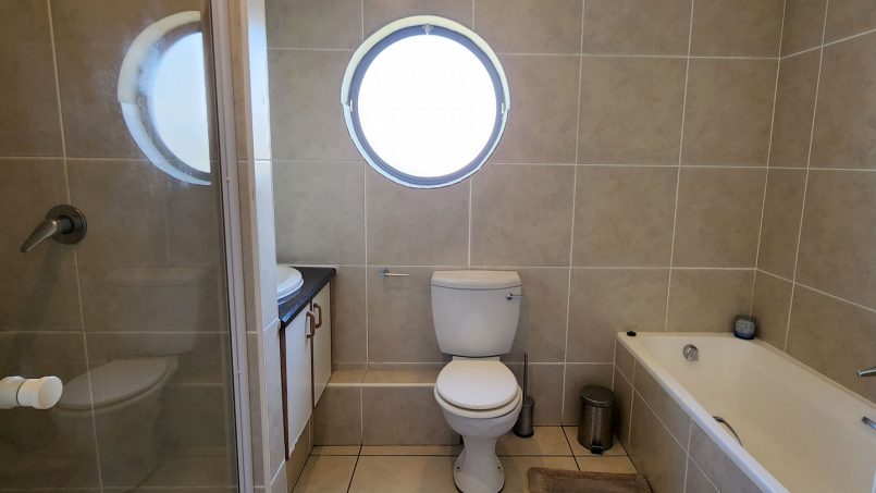 Modern bathroom with a bath and a shower at Indigo Bay 25 self-catering unit