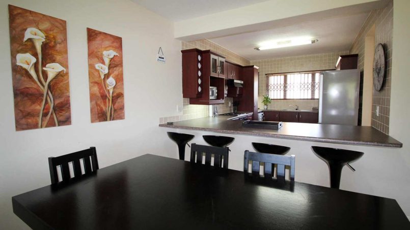 Dining area and kitchen at Le Touessrok 32 Ramsgate self-catering holiday apartment