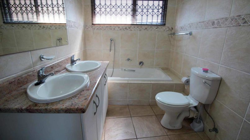 En suite athroom with a bath and a shower at Le Touessrok 32 Ramsgate