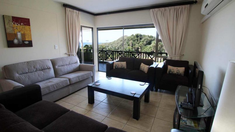 Open-plan lounge at Le Touessrok 32 Ramsgate with balcony and ocean view