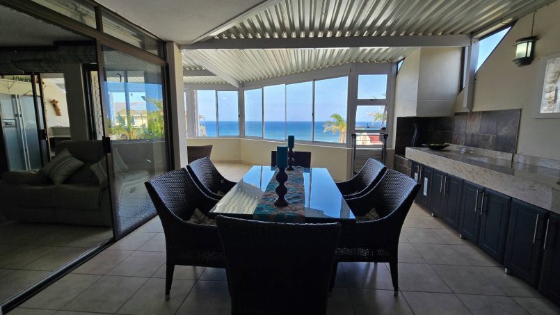 The dining table on the enclosed patio with sea view at Chardonnay Cabanas 5
