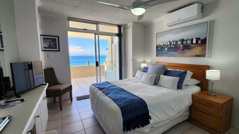 Main bedroom with queen bed and sea view in Octavia 7