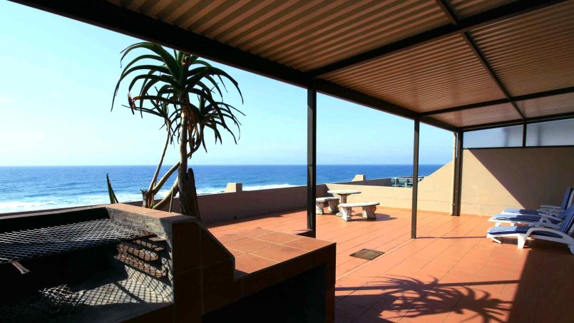 Spacious balcony with outdoor seating and panoramic sea view at C Front 11 Manaba Beach penthouse