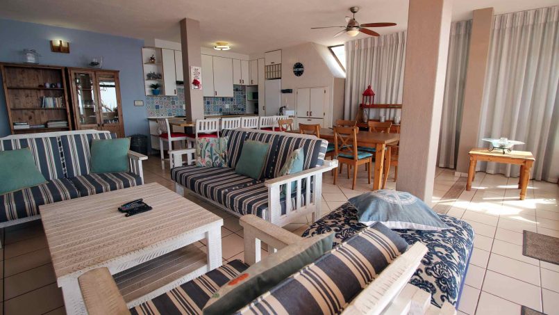 Self-catering penthouse kitchen and dining area with seating for family holidays