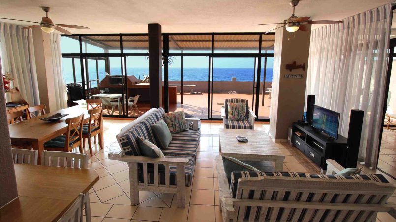 Bright open-plan lounge with large windows overlooking the Indian Ocean at C Front 11