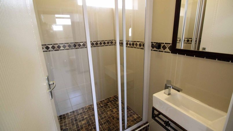 Modern bathroom with walk-in shower in C Front 11 self-catering penthouse