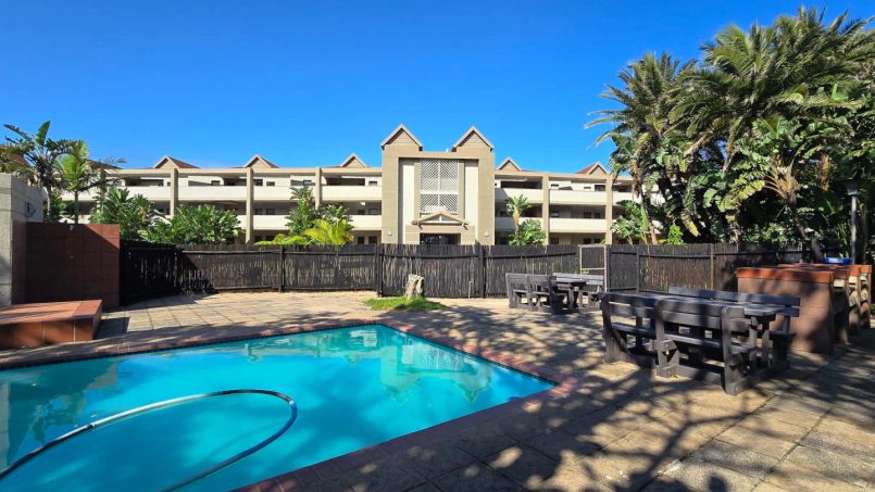 The swimming pool at Portofino complex with shade, and on-site braais —ideal for sunny family days.