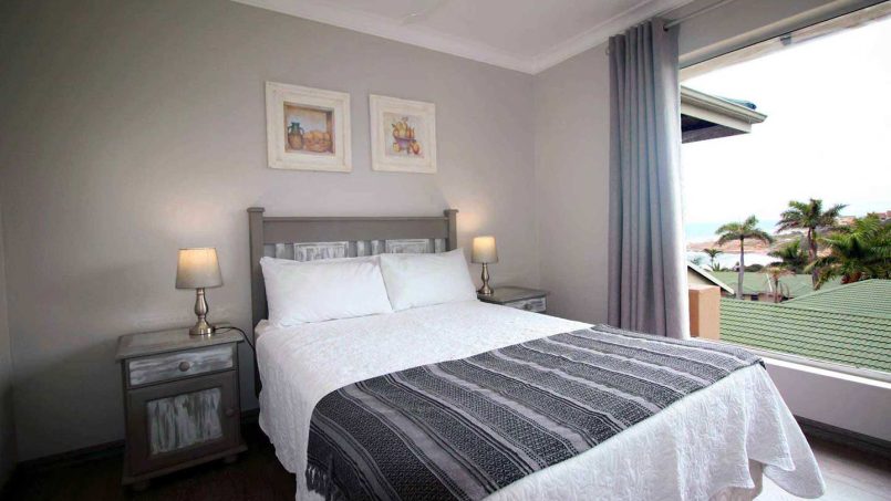 Main bedroom with double bed and sea views at Ramsgate Palms 76