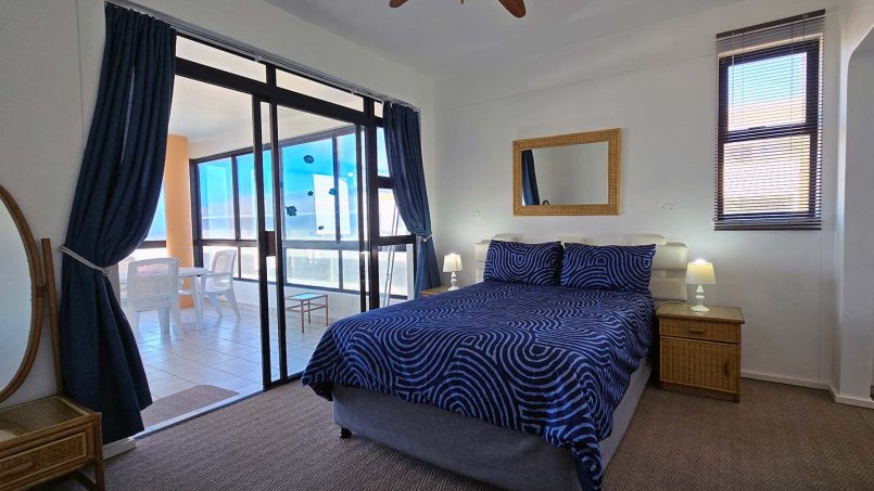 Main bedroom at Margate Sun 11 with sea-facing window and balcony access