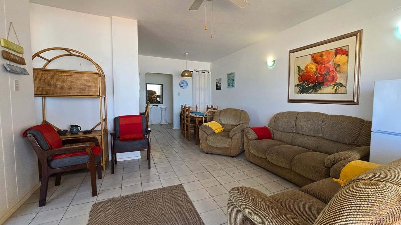 Comfortable open plan lounge at Margate Sun 11 with sliding doors opening to a balcony and sea views over Margate Pier