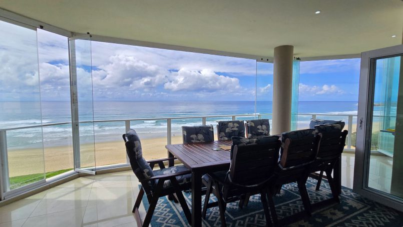 Panoramic sea view from Lucien Sands 501 patio with dining table, Manaba Beach
